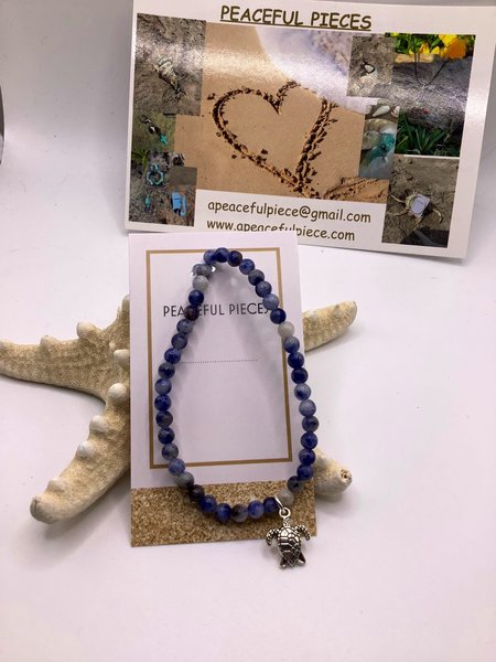 Sodalite gemstone healing bracelet with turtle charm.